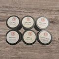 Set of FF branded wax melts on a wooden surface