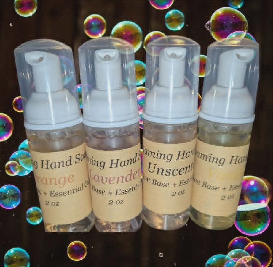 Four bottles of herbal scented hand soaps, on a background of multi-colored bubbles
