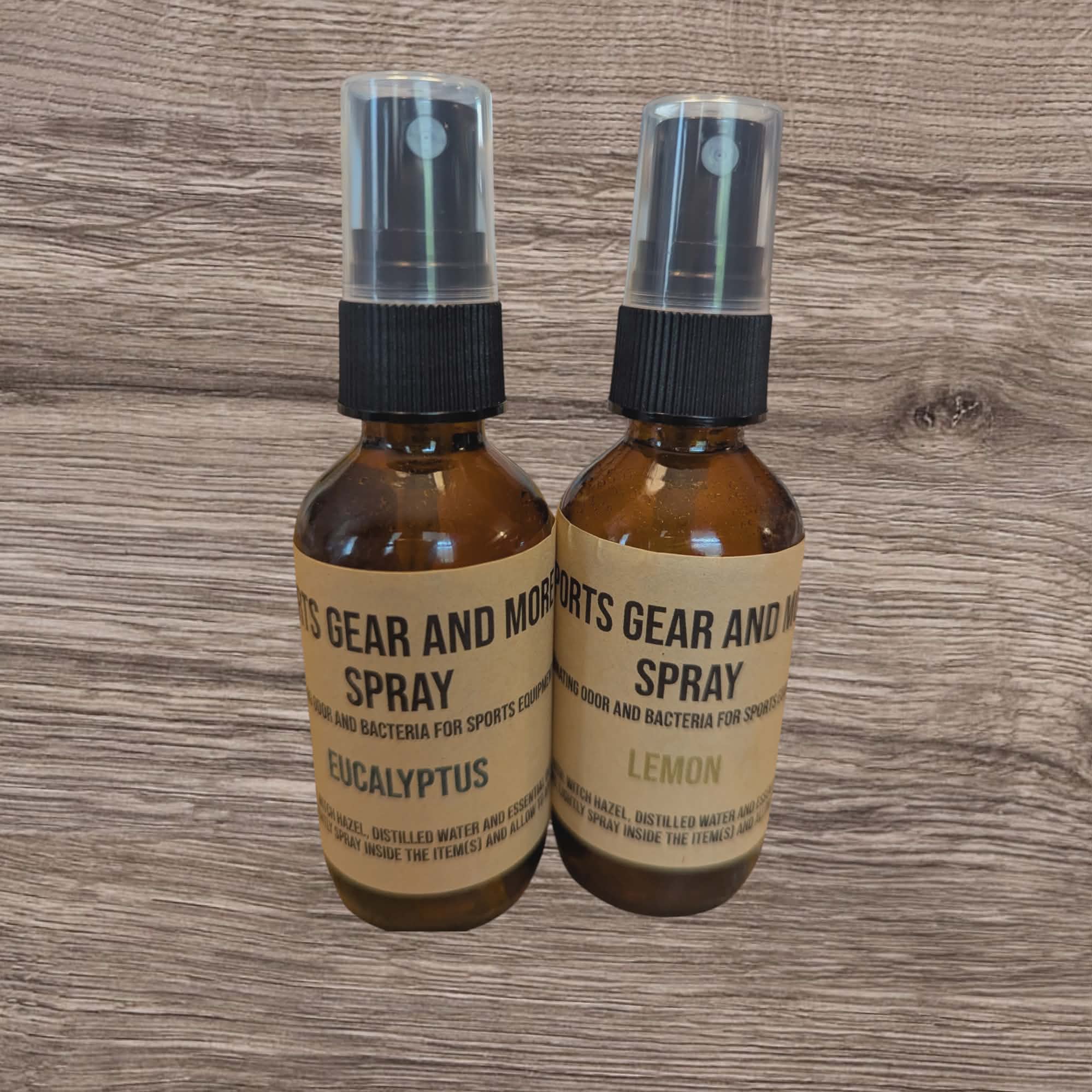 Two brown spray bottles with labels on a wooden surface
