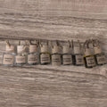 Row of small bottles with labels on a wooden surface