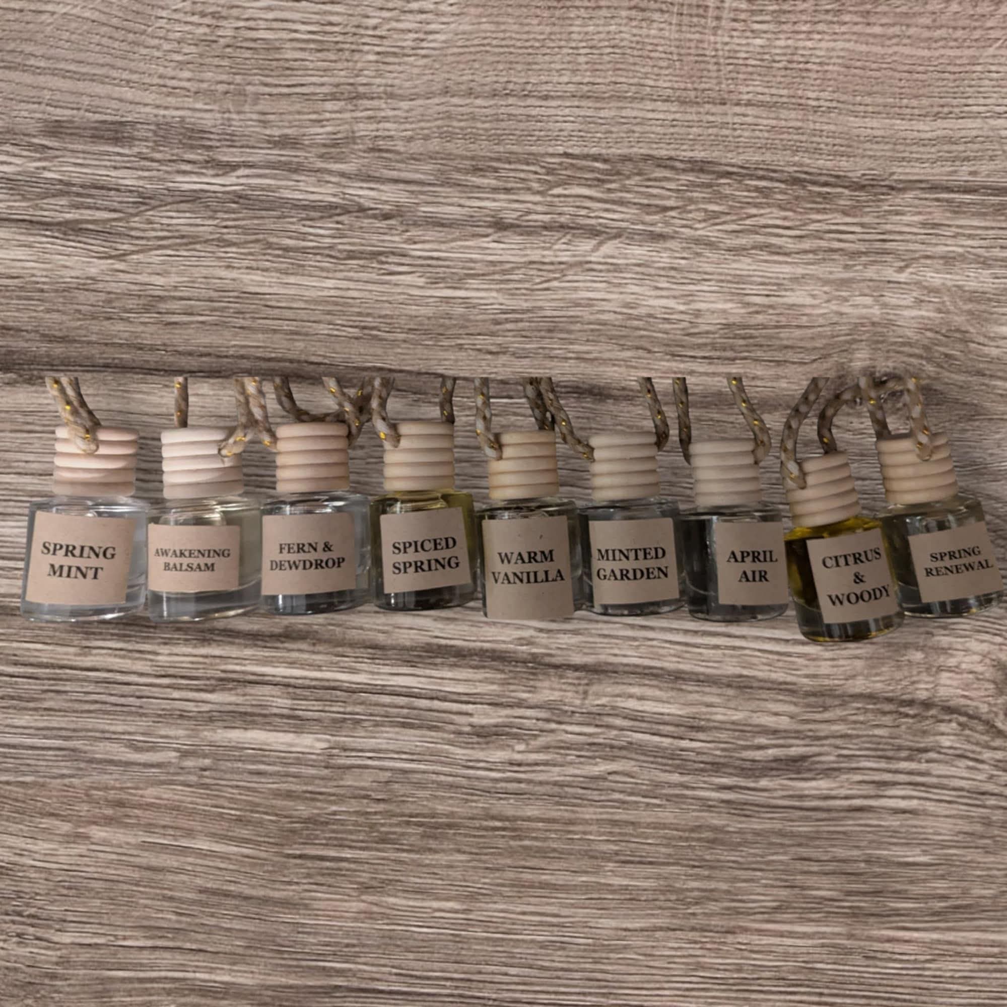 Row of small bottles with labels on a wooden surface