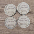 Four tins of Headache Relief Balm on a wooden surface