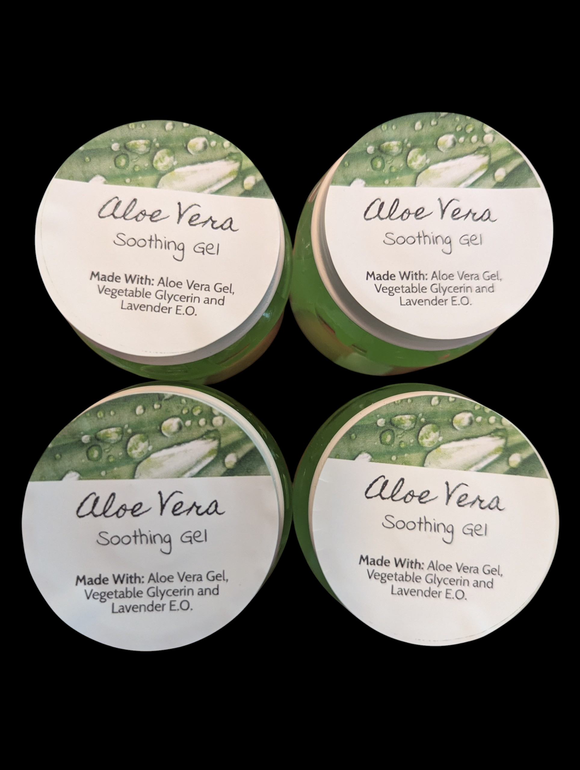 Four containers of Aloe Vera Soothing Gel with green and white labels on a black background.
