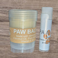 Two paw balms on a wooden surface, one in a jar and one in a stick form.