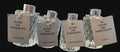 Four room air freshener bottles with labels on a black background
